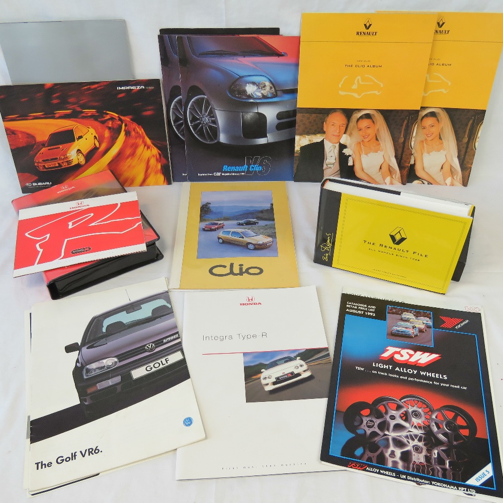 A collection of Renault, VW, Honda and Subaru advertising pamphlets and brochures.