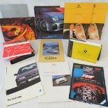 A collection of Renault, VW, Honda and Subaru advertising pamphlets and brochures.