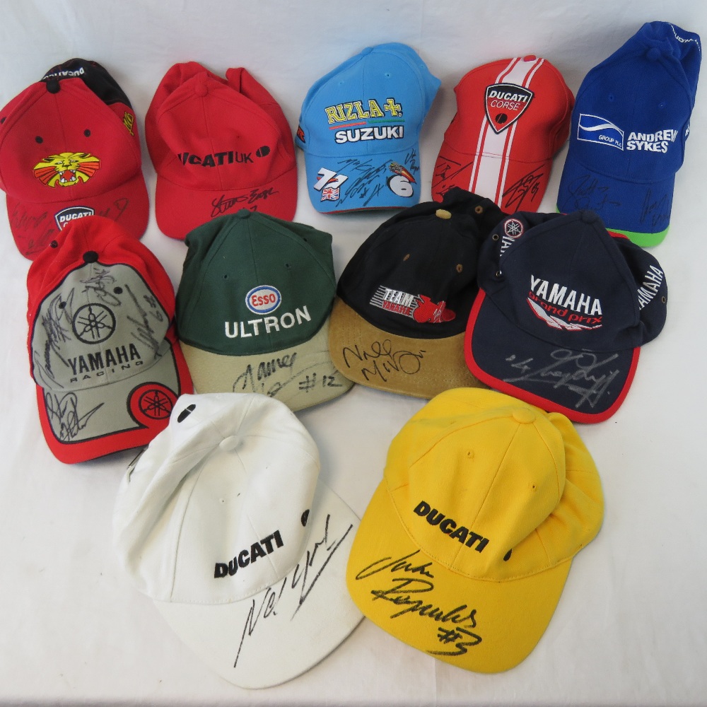 A collection of motor sport caps including Ducati, Yamaha, Suzuki and others,