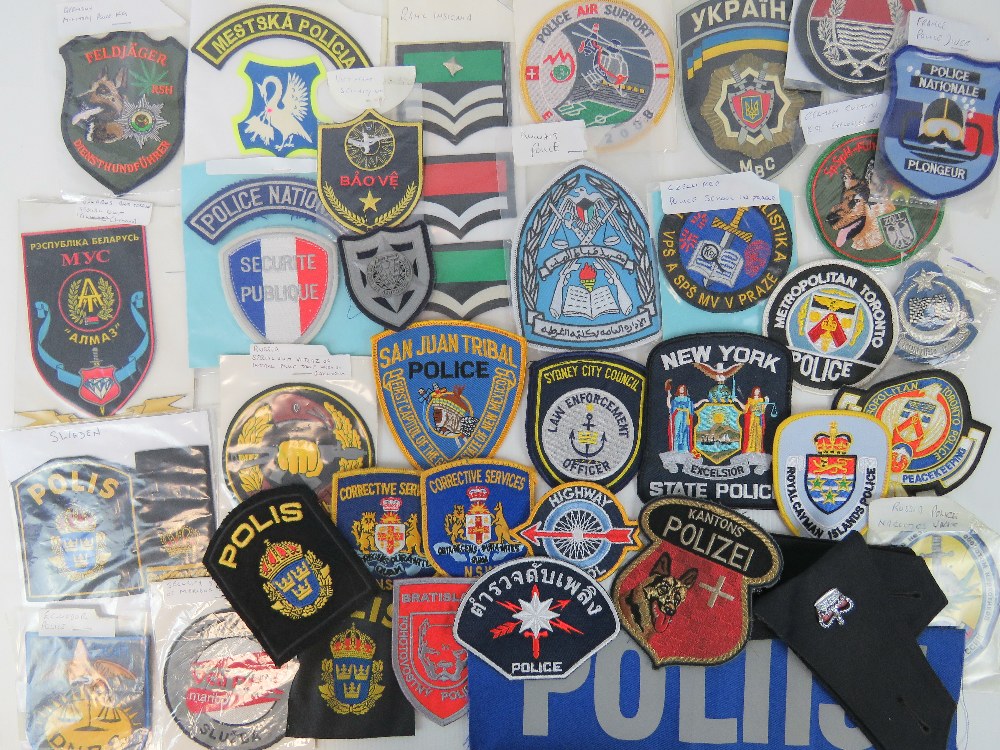 Various cloth police badges including; M
