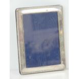 A HM silver photograph frame having beaded border, 15.5 x 12cm, hallmarked London 1994.