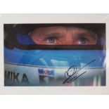 Signed and mounted photographic print; David Coulthard in cockpit - visor raised,