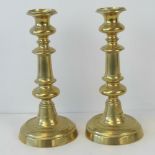 A pair of Victorian heavy brass candlesticks of baluster form with ejectors, 26cm high.