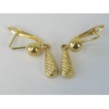 A pair of 18ct gold earrings having hinged hangers and teardrop shaped pendants, hallmarked 750, 3.