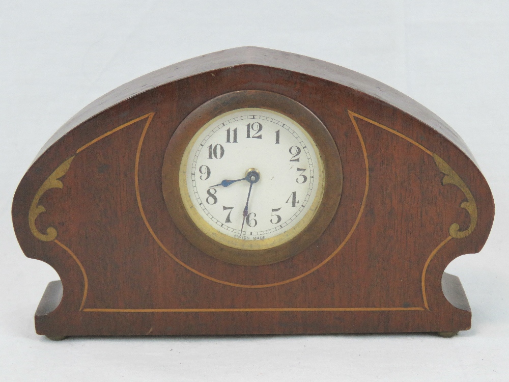 A small Swiss made mantle clock in the Art Nouveau style, mahogany frame and handpainted 'inlay',