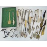 A quantity of silver plated items including; grape scissors, butter knives,