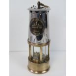 A vintage brass and steel miners oil lamp having plaque marked 'The Protector Lamp & Lighting Co.