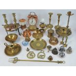 A collection of brass including toasting fork, trivet, two pairs of candlesticks,