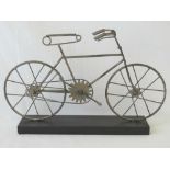 A contemporary metal desk ornament in the form of a bicycle, 40cm wide.