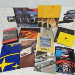 A collection of Renault, VW, Honda, BMW, Ford and Subaru advertising pamphlets,