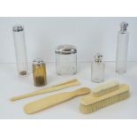 A set of five HM silver and cut glass dressing table bottles including hat pin pot, scent bottle,