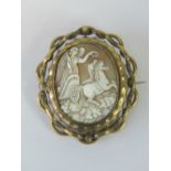 A large Victorian carved shell cameo brooch having Classical female upon chariot to central