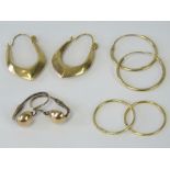 Four pairs of yellow metal earrings; two pairs of training hoops, a pair of hinged back earrings,