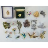 A quantity of assorted 20th century brooches including;