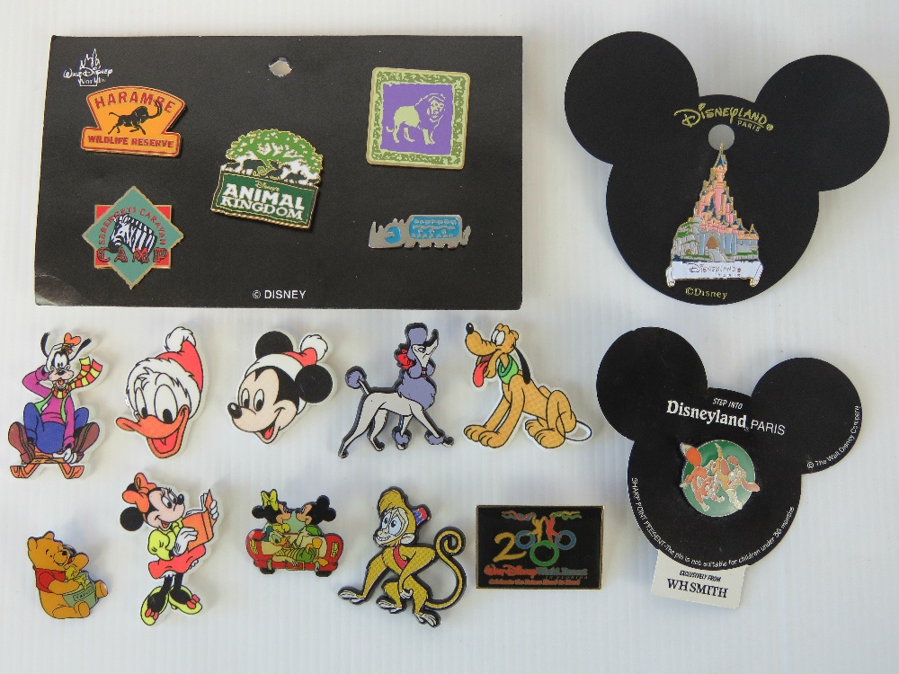 A quantity of Disney badges including; a set of Walt Disney Animal Kingdom badges, Disneyland Paris,