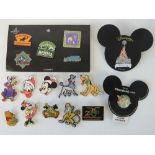A quantity of Disney badges including; a set of Walt Disney Animal Kingdom badges, Disneyland Paris,