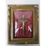 A 19th century figure of Christ upon the cross in part carved frame with relief 'bubble' glass,