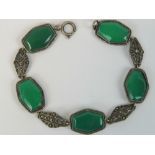A 935 silver bracelet having alternation green glass panels and marcasite set panels, 19.