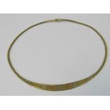 A 9ct gold woven link necklace having central tri-colour articulated brushed gold panel,