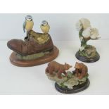 Three Country Artists figurines each comprising doves, bears and blue tits.