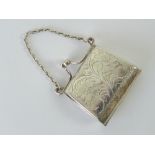A delightful silver miniature purse complete with chain handle and snap closure, stamped 925.