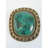 A 935 Mexican silver handmade brooch/pendant having large green agate cabachon to centre, 5cm wide.