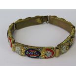 A vintage micro mosaic bracelet having 'Pompei' to central panel flanked by two floral panels to
