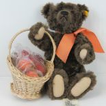 A Steiff 'Autumn' Teddy bear in brown mohair with a basket of apples, 34cm high.