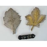 Two silver filigree leaf brooches together with a French jet bar brooch. Three items.