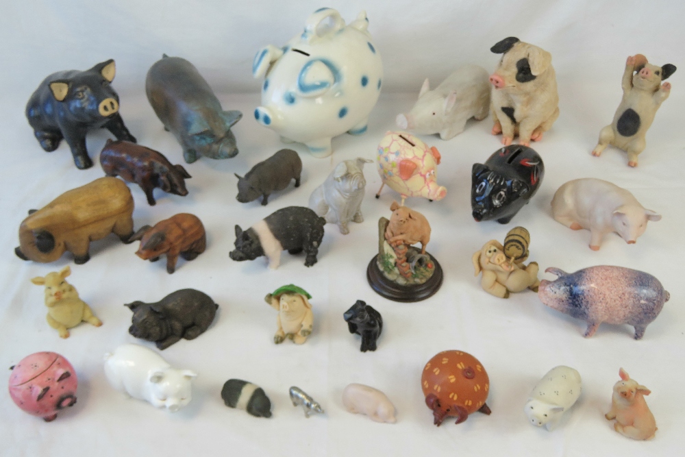 A quantity of assorted contemporary wooden and ceramic pig figurines.