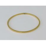 A yellow metal bangle, resized, no apparent hallmarks, 6.12g.