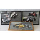 Three photographic prints of Formula 1 racing cars on the track, framed and glazed.