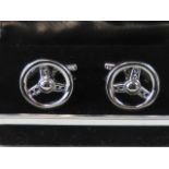 A pair of as new steering wheel cufflinks in presentation box.