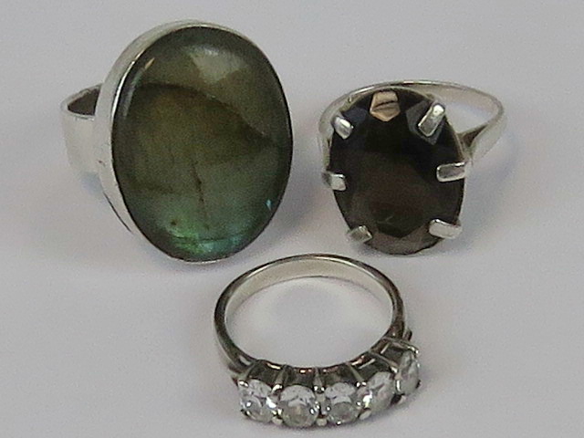 Three silver rings; abalone shell size O