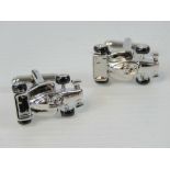 A pair of as new F1 racecar cufflinks in