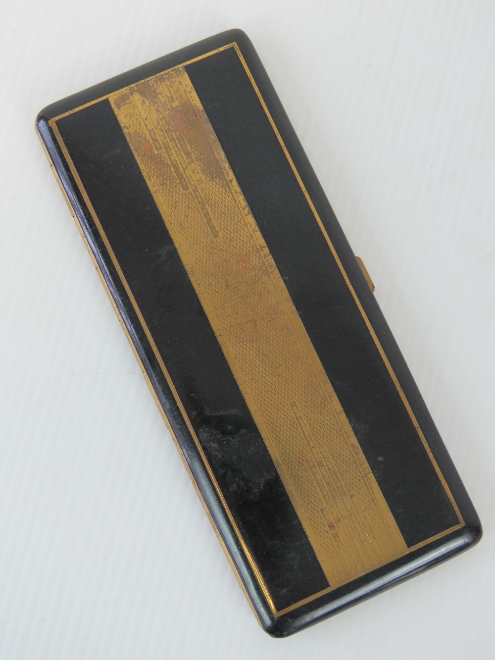 A French Art Deco black enamel cigarette