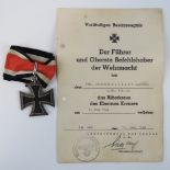 An 1813-1939 Iron Cross with ribbon and complete with document for June 1944 Uffz.