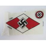 A WWII German 1933 Adolf Hitler party badge, together with a German Youth HJ cloth patch.