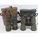 A pair of binoculars in leather carry case.
