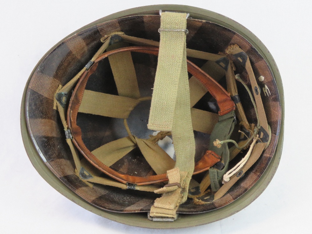 A US WWII M1 Infantry issue helmet with original liner and chinstrap having plain olive drab paint, - Image 2 of 2