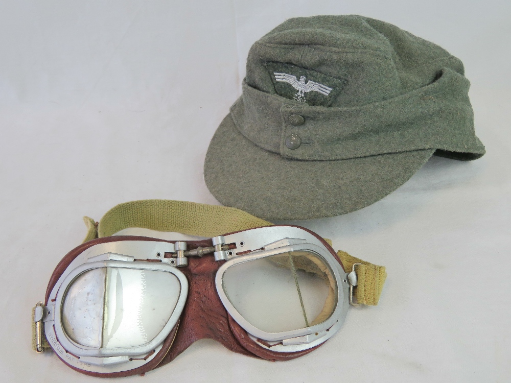 A WWII German Wehrmacht green ski cap with Motorcycle/Pilots goggles.