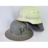 Two wartime fire helmets; one WWII British SFP helmet dated 1941,