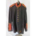 A WWII US Military Band Corps parade tunic, in black with red details and original buttons.