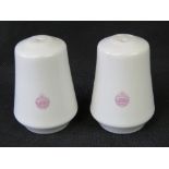 A pair of ceramic salt and pepper cellars in white ground with Tank Corp insignia transfer upon.
