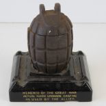 A WWI Mills Grenade casting converted into a match pot, raised over smokers receptacle base,