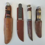 Four hunting knives; two with Sheffield steel blades, each having leather sheath.