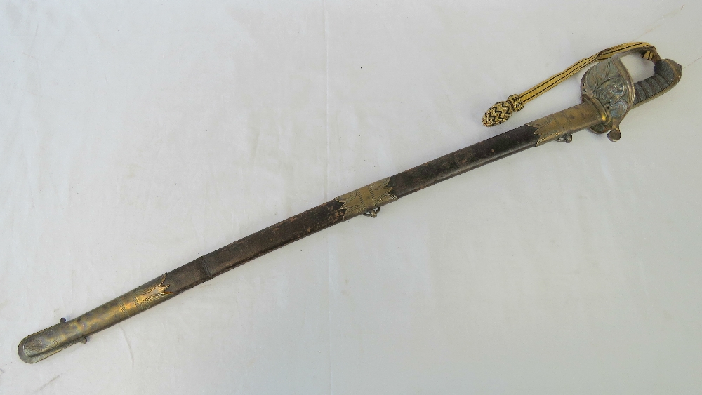 A Victorian naval sword having black and gilt thread portapee, leather scabbard with brass fittings,