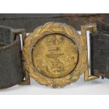 A Victorian Naval Reserve belt having brass wreath buckle and original brown leather belt.