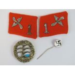 A reproduction German NSFK badge, a pair of reproduction officers collar boards,