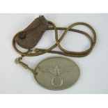 A Gestapo Officers identification disc with chain hanger and leather fob,